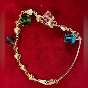 Yellow gold ID Bracelet with green and blue gem charms in 14k yellow gold.